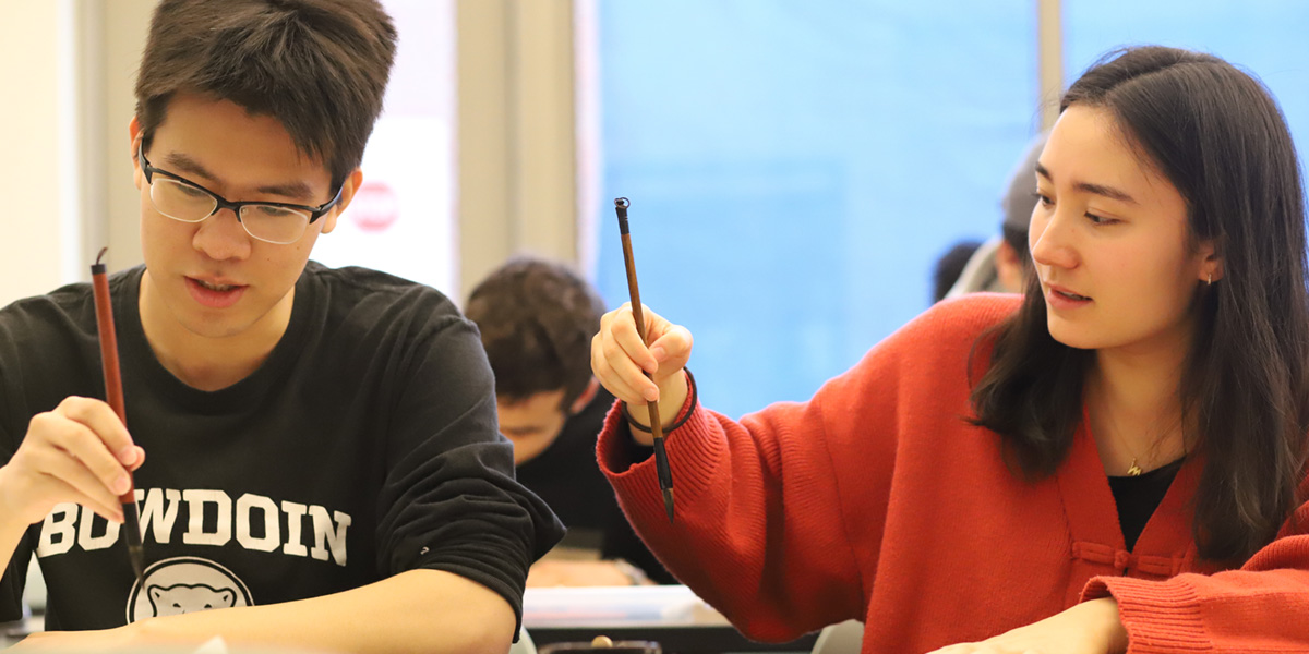 Bowdoin students practice in Chinese calligraphy class.